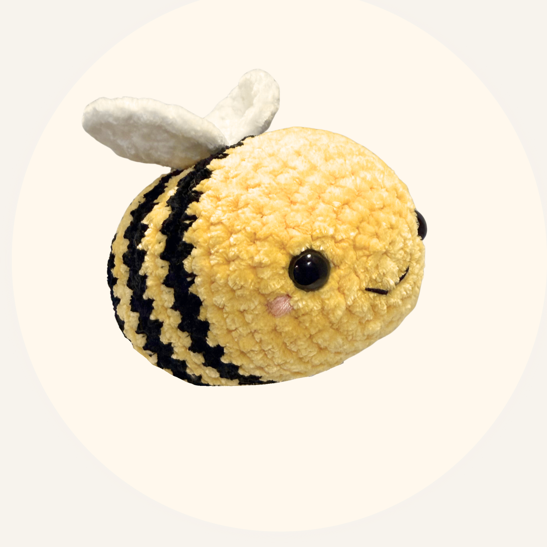 Plush bee toy with black stripes on a white background